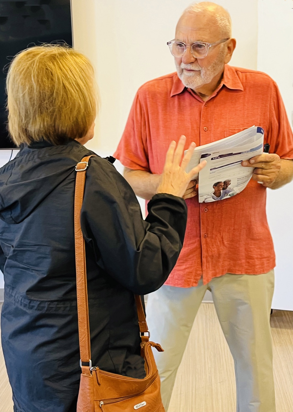 Pete Kote speaking with a workshop participant.