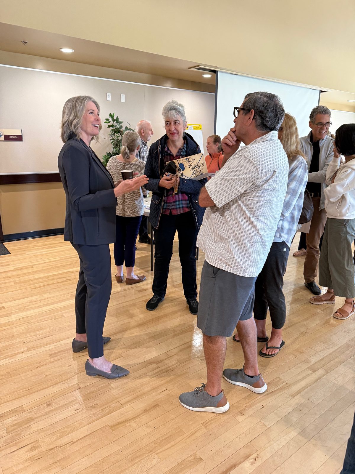 Workshop participants speaking with an adviser after a community event.