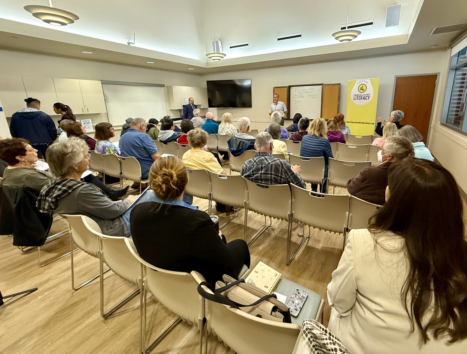 Financial literacy workshop with community members seated for a presentation.
